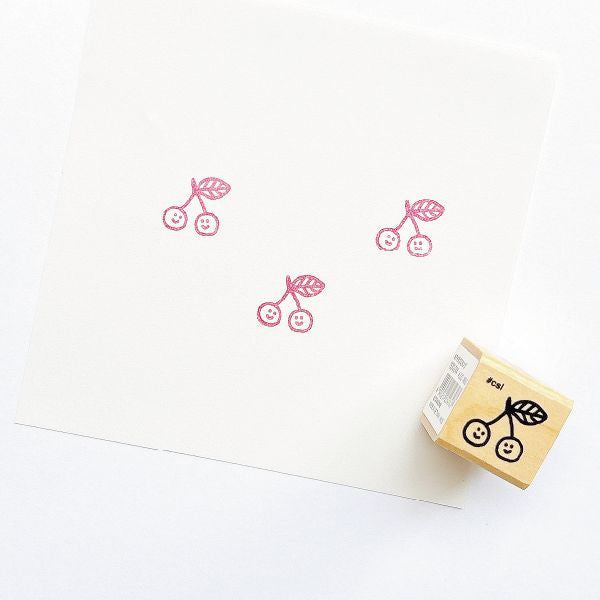 Cherry stamp with a matching stamp on a white background