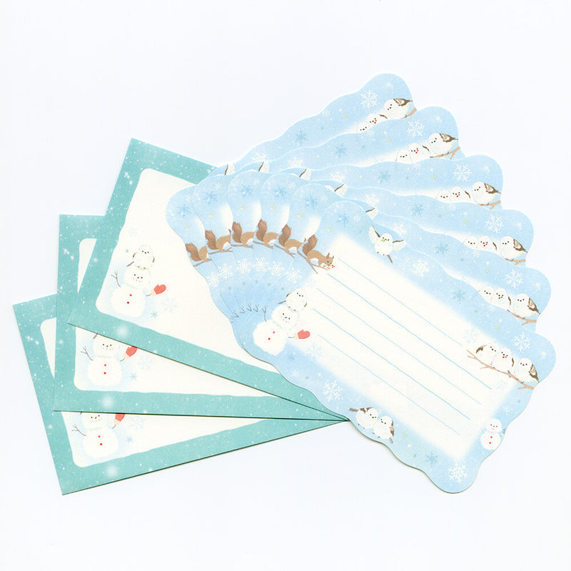 Set of stationery items with snowman design on a white background