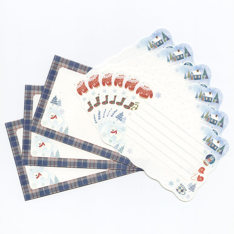 Set of stationery items with plaid designs and winter-themed illustrations on a white background