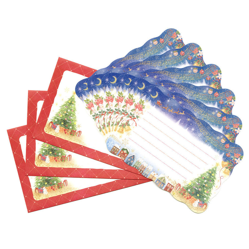 Set of Christmas-themed stationery items including paper and envelopes on a white background
