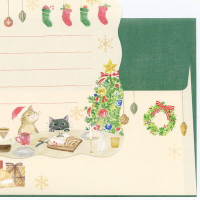 Christmas-themed stationery set with cats, tree, and wreath on a beige background