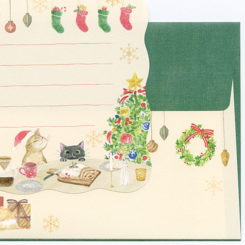Christmas-themed stationery set with cats, tree, and wreath on a beige background