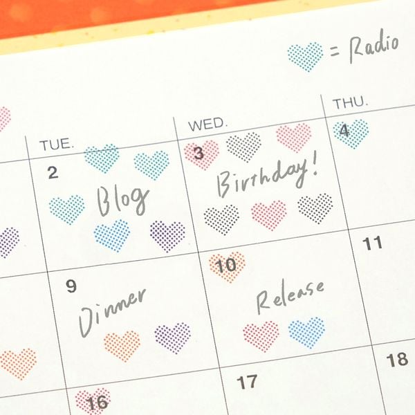 Calendar with heart-shaped notes and handwritten tasks on a colorful background
