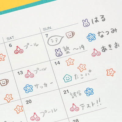 Colorful calendar with hand-drawn symbols and Japanese text on a white background