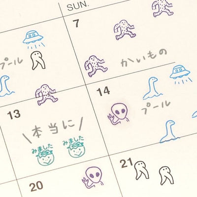 Calendar with hand-drawn alien and UFO illustrations on each day