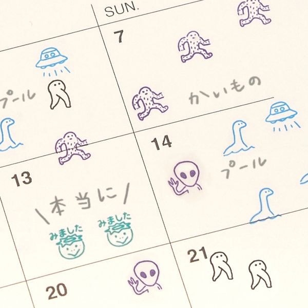 Calendar with hand-drawn alien and UFO illustrations on each day