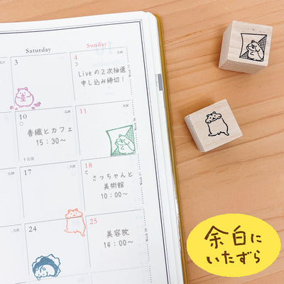 Calendar with cute animal stamps on a wooden surface