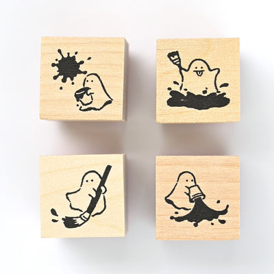 Four wooden stamps with ghost illustrations on a white background