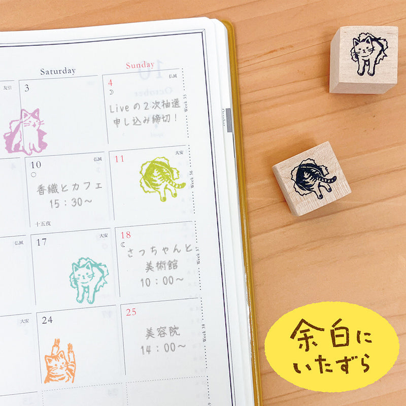 Calendar with animal stamps on a wooden surface