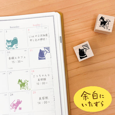 Calendar with dog-themed stamps on a wooden surface