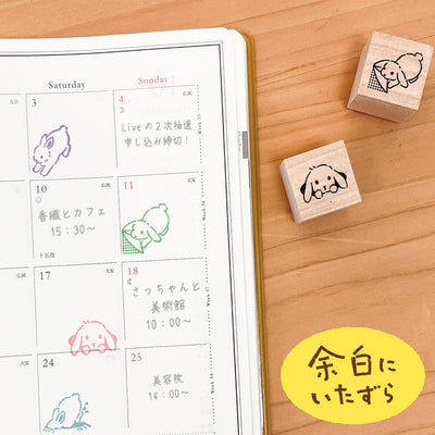 Calendar with hand-drawn stamps of a rabbit on a wooden surface
