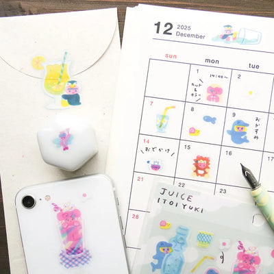 Phone case with cartoon designs, calendar with stickers, and pen on a wooden surface