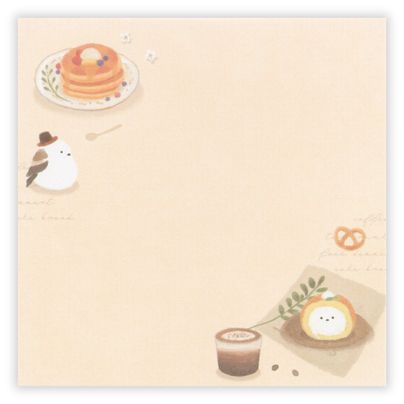 Illustrated notepad with food-themed design on a beige background