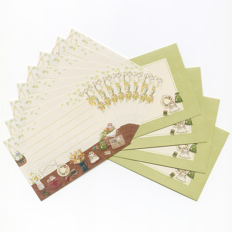 Set of stationery items including letters and envelopes with decorative designs on a white background