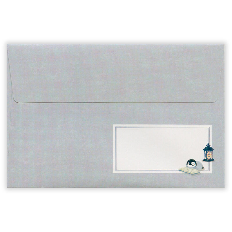 Gray envelope with a white windowed insert featuring a penguin and lantern design.