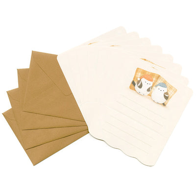 Set of brown envelopes and a beige notepad with a bird illustration on a white background