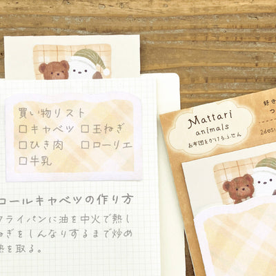 Set of stationery items with bear designs on a wooden surface