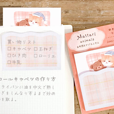 Set of cute animal-themed notepads with cartoon characters on a wooden surface.