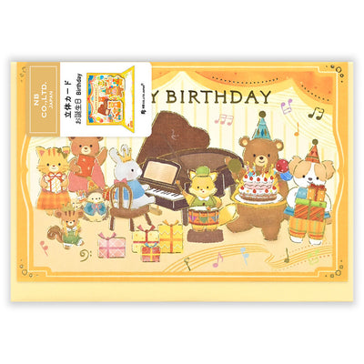 Birthday card with cartoon animals around a piano and cake, featuring the brand 'NB'.