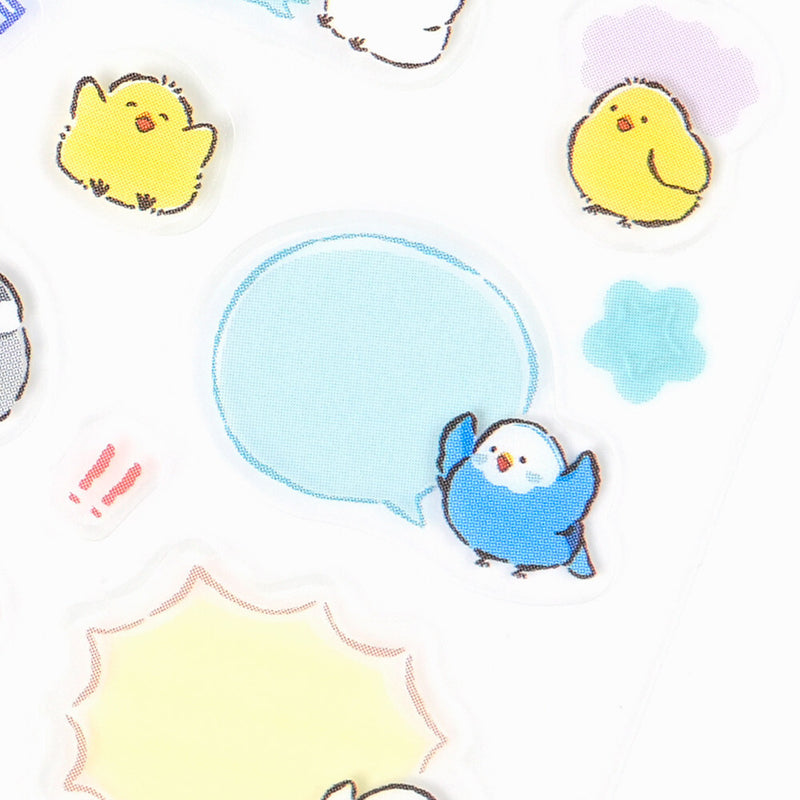 Cartoon-style blue bird with a speech bubble surrounded by yellow chicks and colorful shapes on a white background.