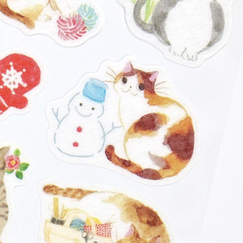Set of decorative stickers featuring a cat, snowman, and other elements on a white background.
