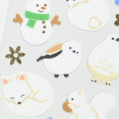 Set of winter-themed stickers including a snowman, penguin, and fox on a white background.
