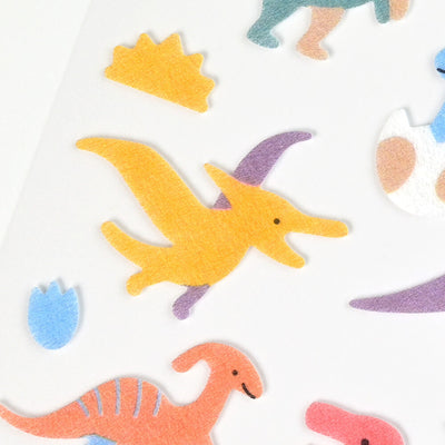 Colorful dinosaur-shaped stickers on a white background