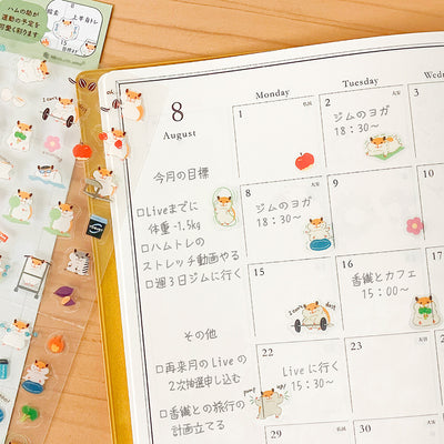 Calendar with cartoon hamster designs on a wooden surface