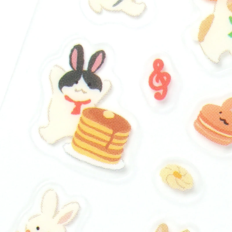 Illustrations of a rabbit and pancakes on a white background