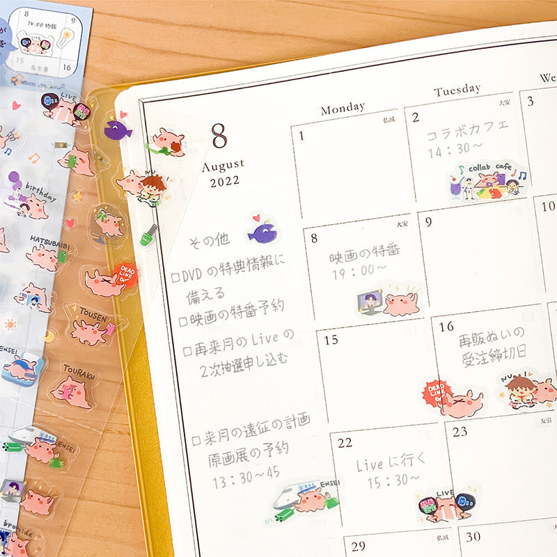 Calendar with cartoon stickers on a wooden surface