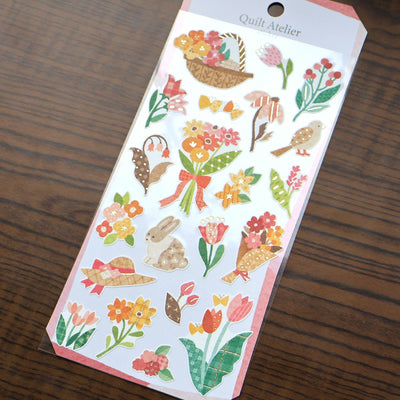 Pack of decorative stickers with floral and nature-themed designs on a wooden surface.