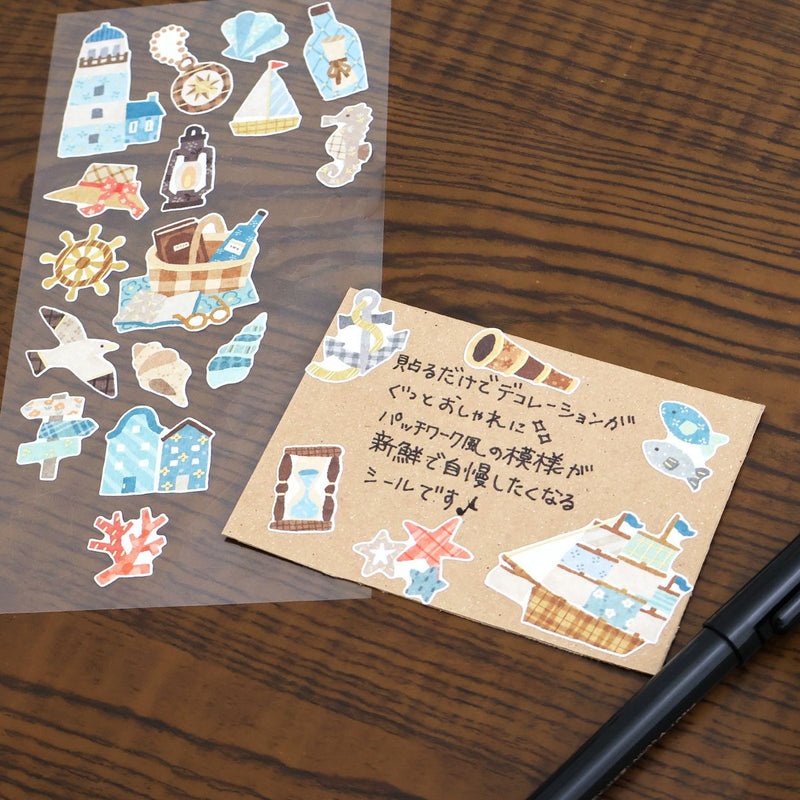 Set of decorative stickers on a piece of paper with a pen on a wooden surface