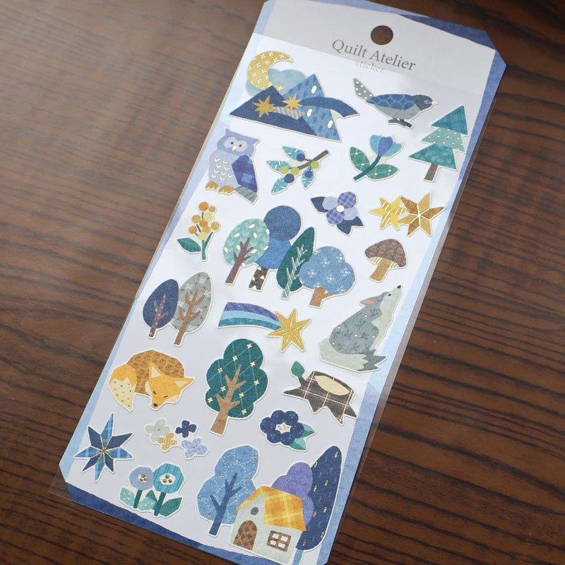 Pack of nature-themed stickers with trees, flowers, and animals on a wooden surface