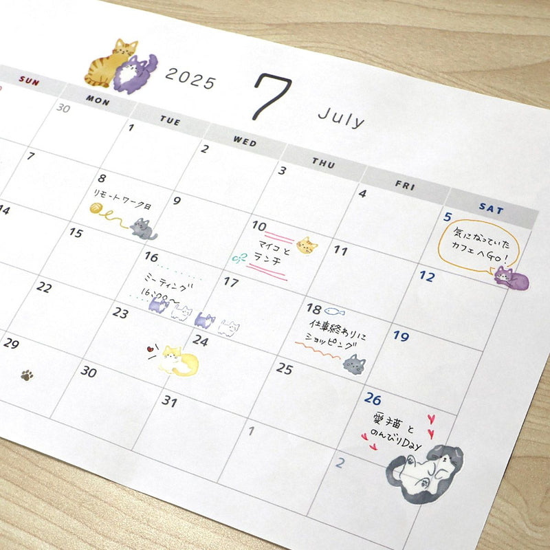 Calendar for July 2025 with cute animal illustrations on a wooden surface
