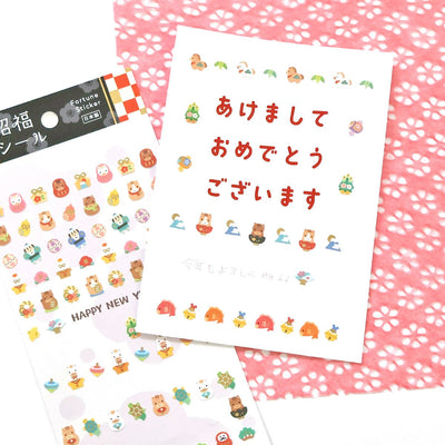 Sheet of decorative stickers with cartoon characters on a pink floral background