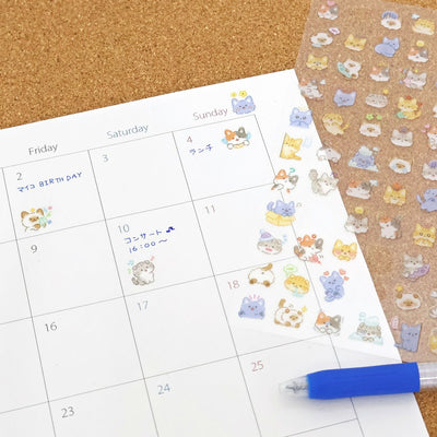 Calendar with cute animal stickers on a cork board