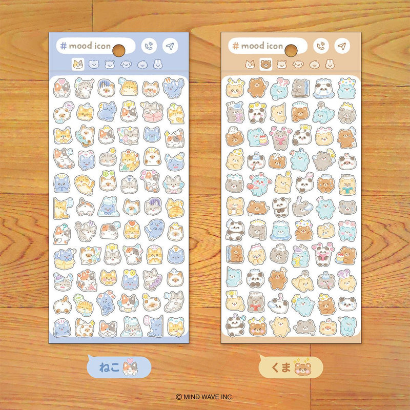 Two sheets of cute animal-themed stickers on a wooden surface
