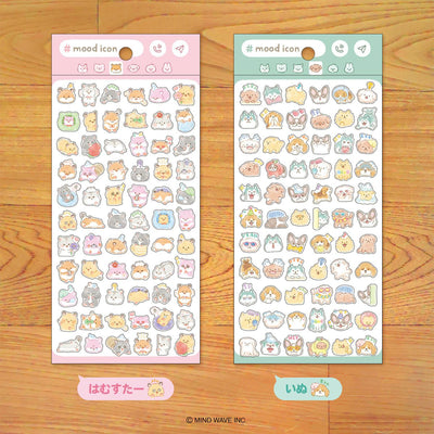Two sheets of cute animal-themed stickers on a wooden surface