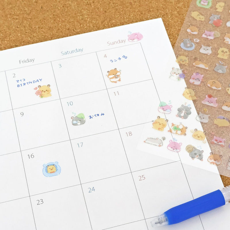 Calendar with cute animal stickers on a cork board