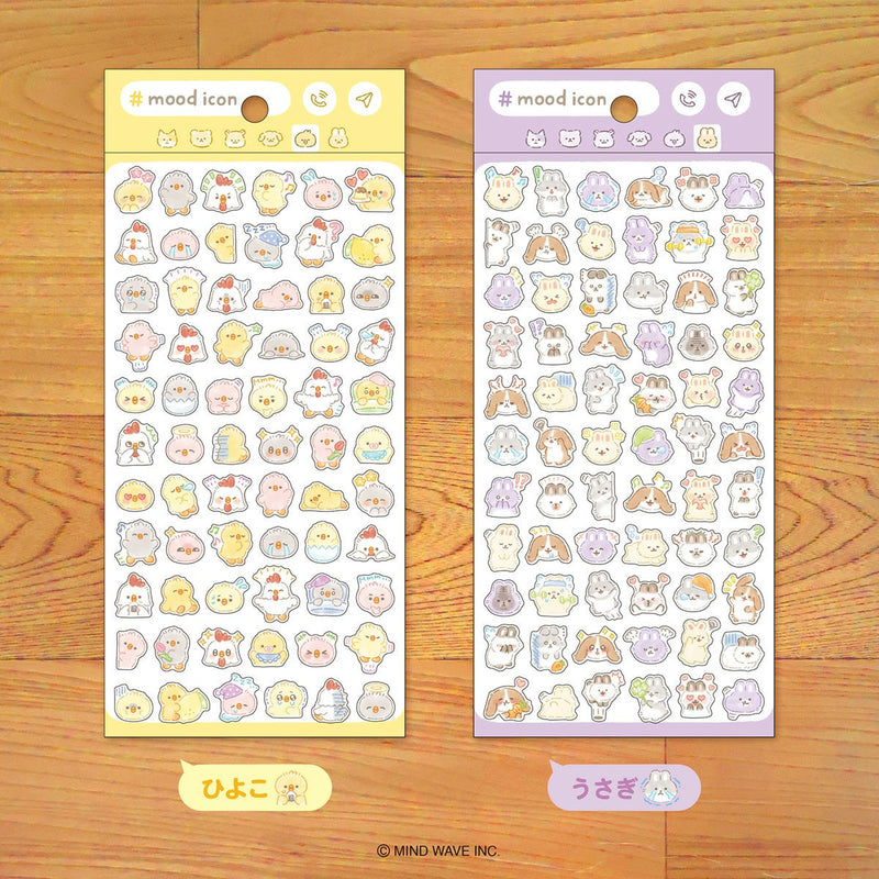Two sheets of cute animal-themed stickers on a wooden surface