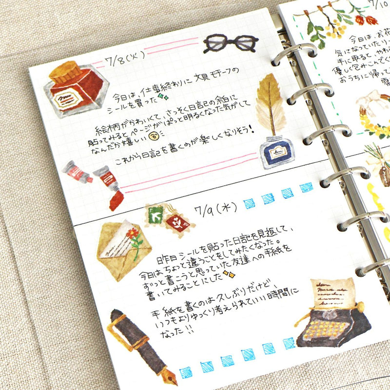 Planner with illustrated pages featuring stationery items on a textured surface