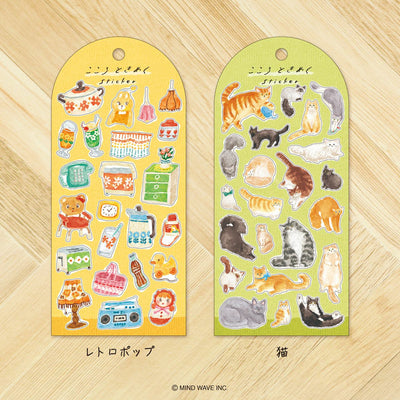 Two sticker sheets with various illustrations on a wooden surface