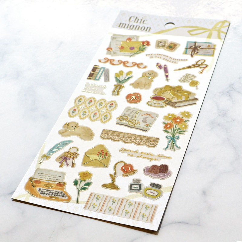 Sheet of decorative stickers with vintage-themed illustrations on a white marble surface.