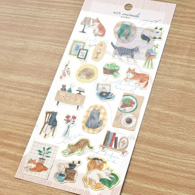 Sheet of stickers with various cat illustrations on a wooden surface