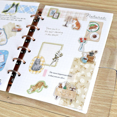 Sticker sheet with illustrations of animals and nature on a wooden surface