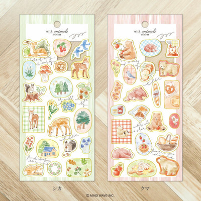 Two sheets of animal-themed stickers on a wooden surface
