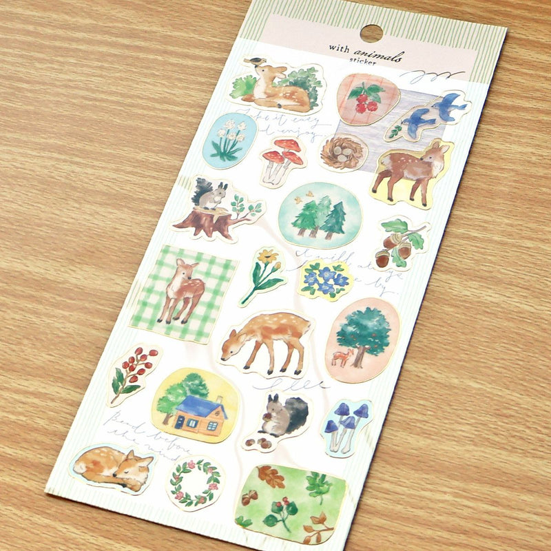 Sheet of nature-themed stickers with animals and plants on a wooden surface