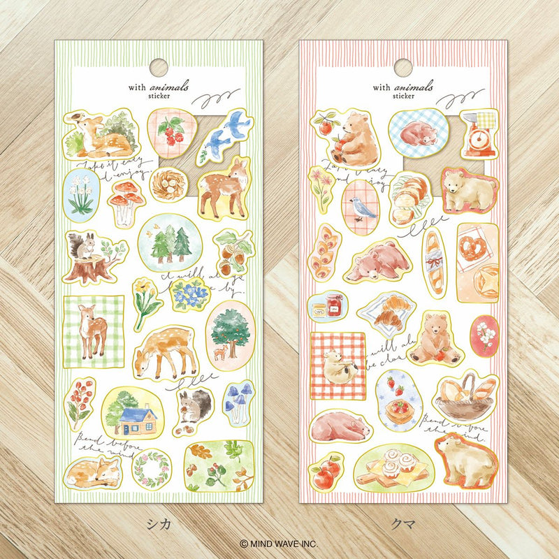 Two sheets of animal-themed stickers on a wooden surface
