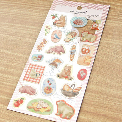 Sheet of decorative stickers with animal designs on a wooden surface