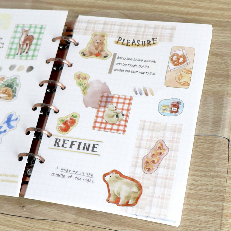 Sticker sheet with illustrations and text on a wooden surface